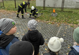 Strażacy przygotowują pokaz gaszenia płonącego oleju.
