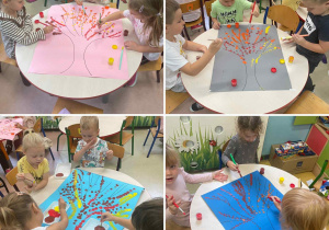 Dzieci z grupy Szkraby w małych zespołach malują jesienne drzewo farbami plakatowymi.