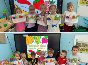 Dzieci z grupy Szkraby prezentują owoce wyklejone plasteliną na tle napisu Światowy Dzień Owoców i Warzyw.