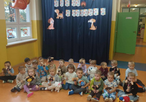 Zdjęcie grupowe dzieci z grupy Kamyczki w Dniu Kundelka na korytarzu przedszkolnym.