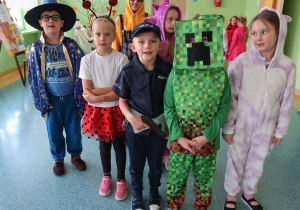 Kilkoro uczniów na korytarzu szkolnym w bajkowych strojach.