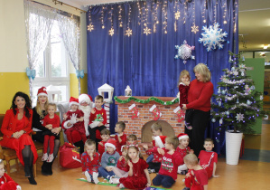 Grupa Szkraby w towarzystwie św. Mikołaja oraz pani Dyrektor Agaty Ewy Ostalskiej i Zastępcy Wójta pani Iwony Łuszcz-Krawczyk.