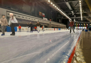 Uczniowie podczas jazdy na łyżwach na torze lodowym.