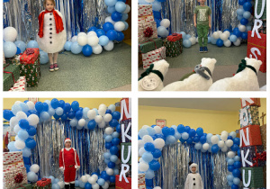 Dzieci na tle balonowej ścianki w przebraniach bałwanków, Mikołaja, zielonego ludka.