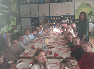 Uczniowie klasy IV wraz z wychowawcą przy wigilijnym stole.