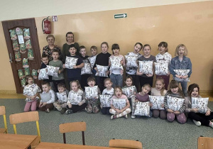 Uczestnicy warsztatów krawieckich ze Szkoły Filialnej w Sadykierzu wraz z organizatorkami spotkania prezentują swoje własnoręcznie wykonane poduszki.