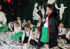 Dwie dziewczynki przebrane za czarownice na miotle.