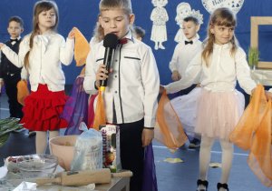 Chłopiec z grupy Skoczki recytuje wiersz w czasie części artystycznej z okazji Dnia Babci i Dziadka.