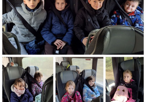 Pierwszoklasiści z zapiętymi pasami siedzą w autobusie.