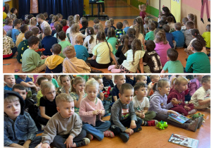 Przedszkolaki z zaciekawieniem oglądają prezentacje multimedialną o dinozaurach.