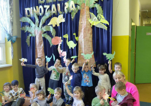 Dzieci z grupy Kamyczki z dumą prezentują swoje prace wykonane w Dniu Dinozaura.