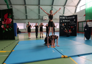 Uczennice klasy V prezentują pokaz akrobatyczny na materacach.