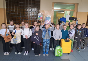 Uczniowie klasy I prezentują soje ciekawe pomysły pokazując co przynieśli w zastępstwie za plecak.