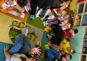 Przedszkolaki z grypy Promyczki wraz z Ciocią Sylwią oraz Uczennicą klasy VI prezentują swoje dwie różne skarpetki.