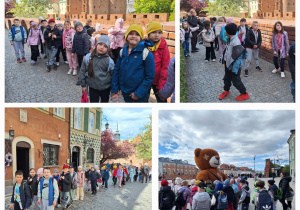 Uczniowie spacerują, a w oddali widać Barbakan w Warszawie.