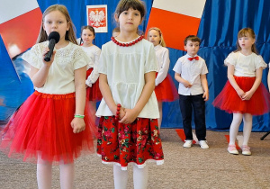 Uczennica recytuje wiersz o Polsce.